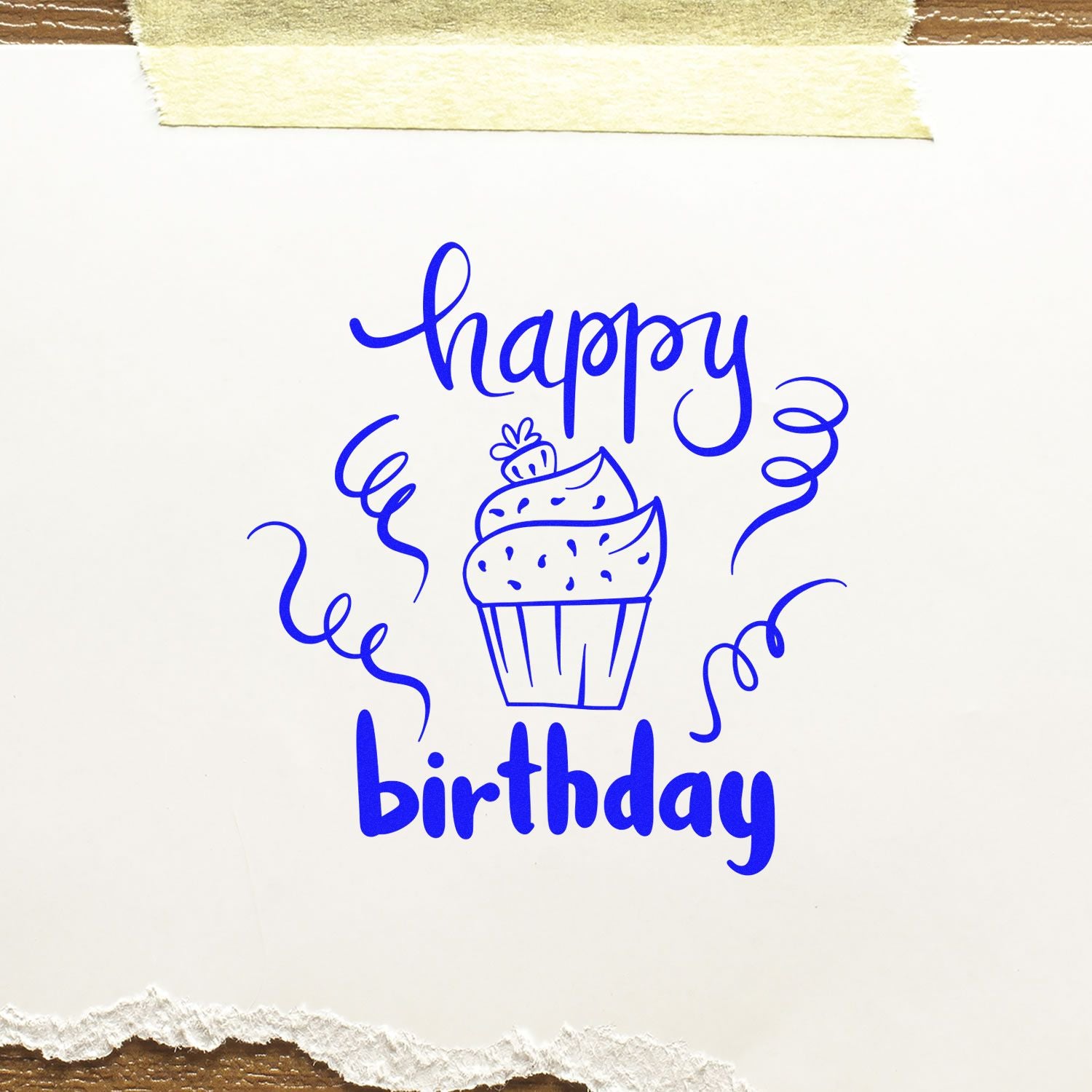 Blue happy birthday rubber stamp with cupcake and confetti, ideal for birthday cards and craft projects.