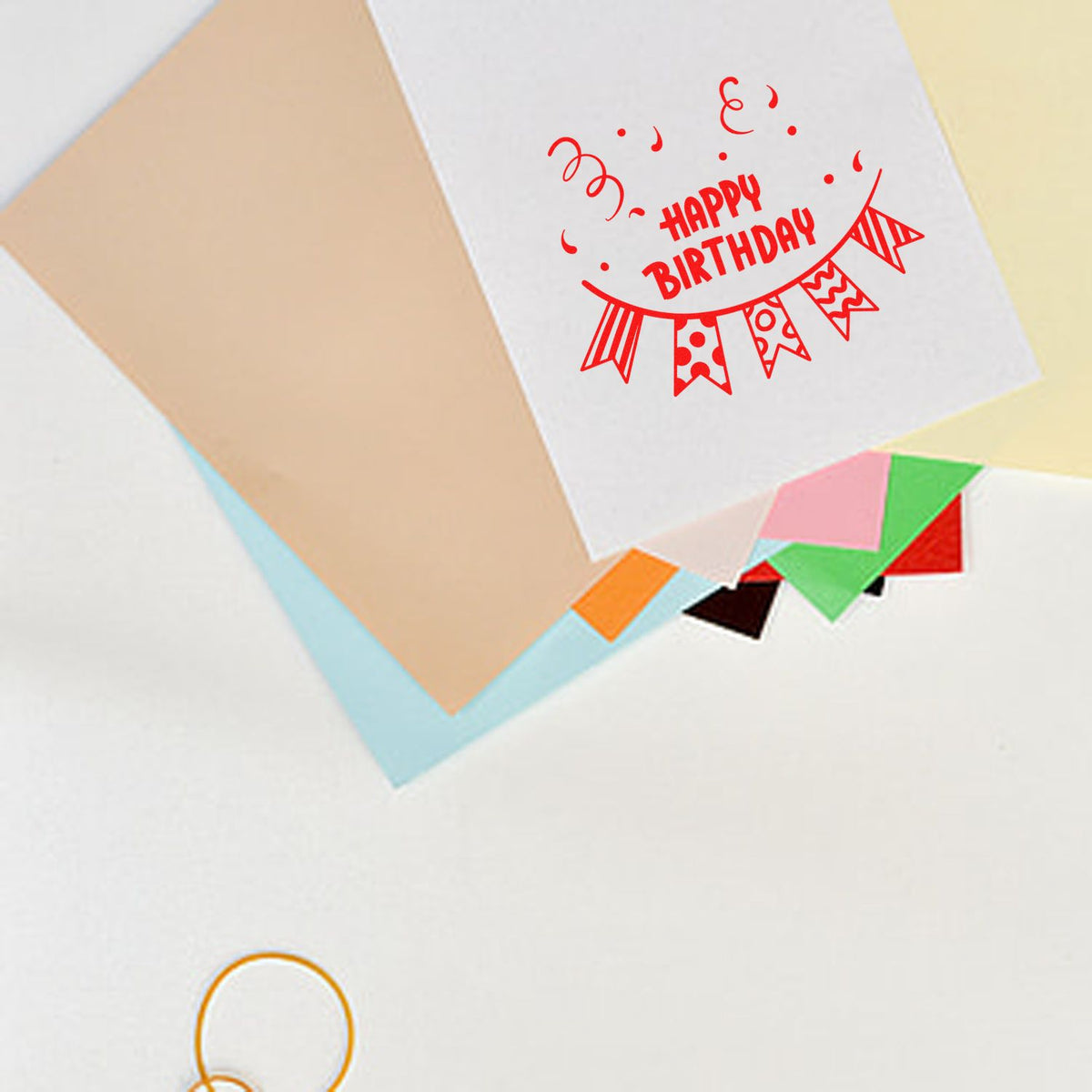 Happy Birthday rubber stamp design on greeting card with festive bunting and confetti