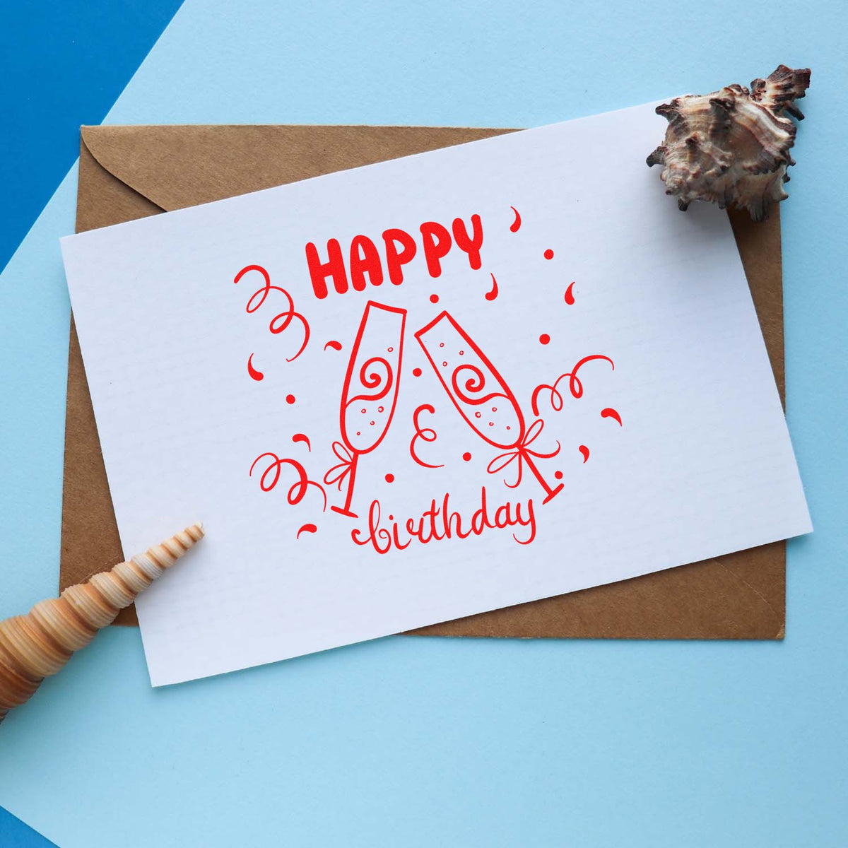 Happy birthday rubber stamp design with champagne glasses on a greeting card, perfect for handmade party cards and invitations.
