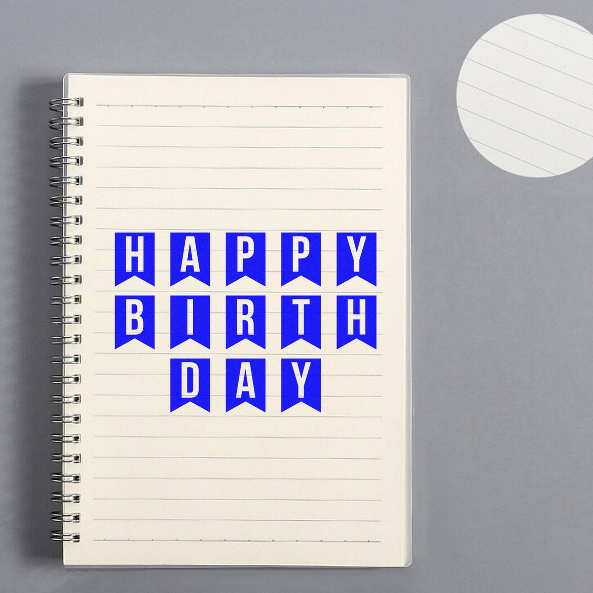 Happy Birthday rubber stamp design on notebook page, perfect for birthday cards, scrapbooking, and DIY craft projects.