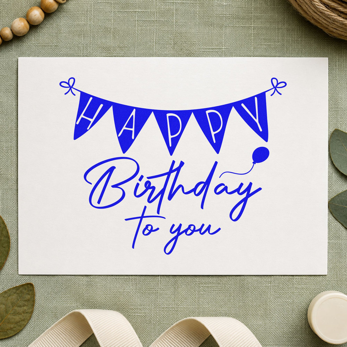 Birthday To You Bunting craft stamp imprinted in blue ink on paper, a design suited to framed sign in table.