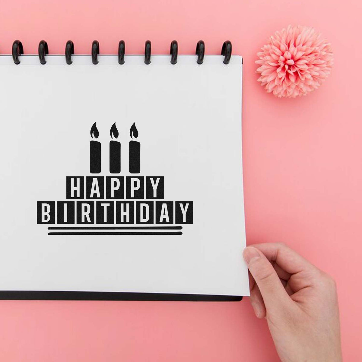 Happy Birthday rubber stamp design with candle icon on notebook, ideal for birthday card making and craft projects.