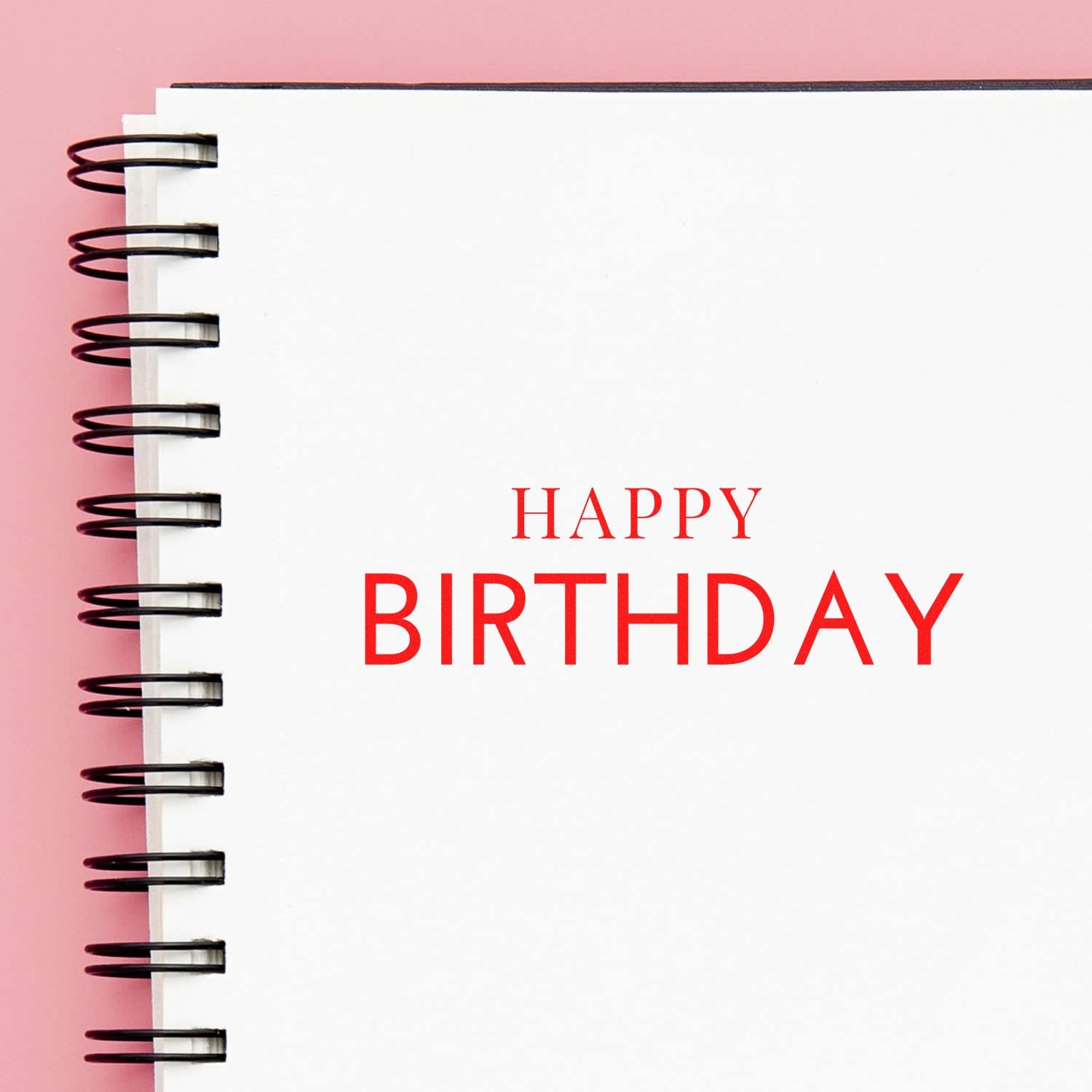 Happy Birthday rubber stamp impression on notebook page for birthday cards, scrapbooking, and craft projects.
