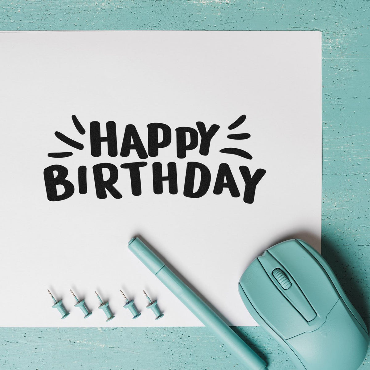 Happy Birthday Radiating Strokes PSI Pre-Inked Stamp imprint stamped in black ink. HAPPY BIRTHDAY appears in chunky playful capitals with radiating strokes at the sides.
