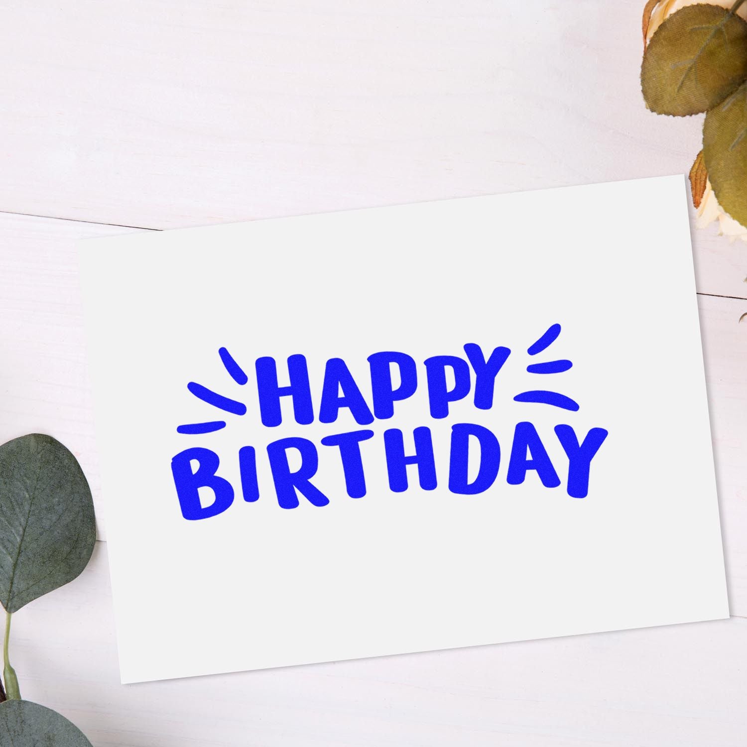 Happy Birthday rubber stamp design in bold blue on white card, perfect for birthday cards, scrapbooking, and craft projects.