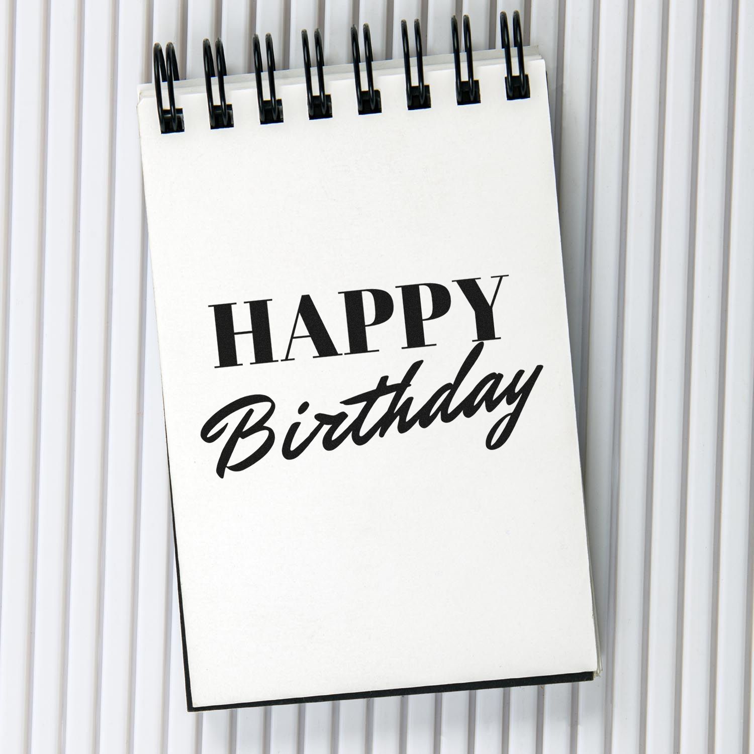 Happy Birthday rubber stamp design on a notepad, ideal for handmade cards, scrapbook pages, and craft projects.