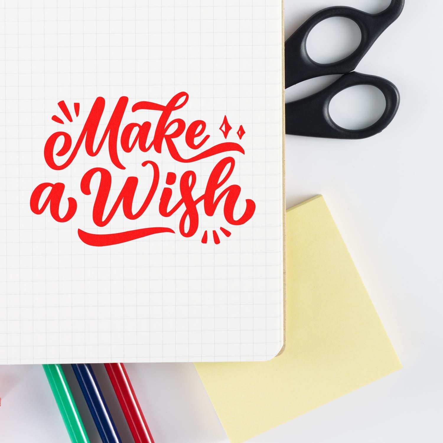 Make a Wish rubber stamp design on notebook with craft supplies, ideal for greeting cards and DIY stationery.