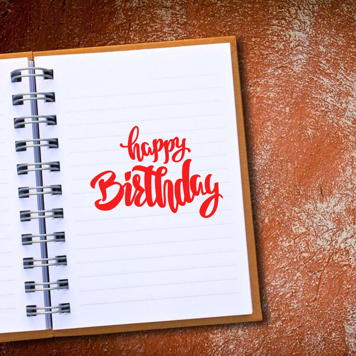 Happy Birthday rubber stamp design in red script on a lined notebook page, ideal for birthday cards, scrapbooking, and crafts.