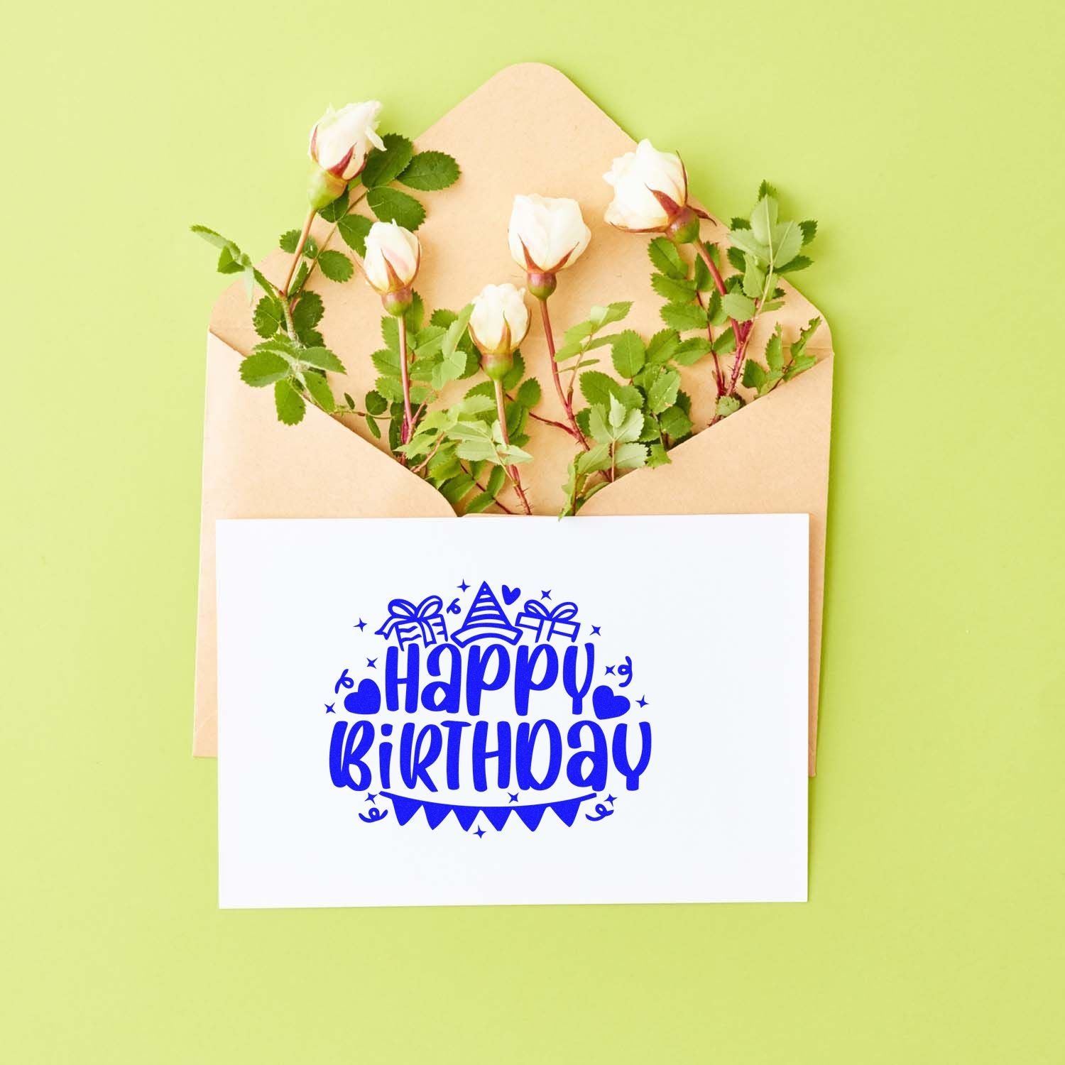 Happy Birthday rubber stamp print on a greeting card, styled with flowers in an envelope
