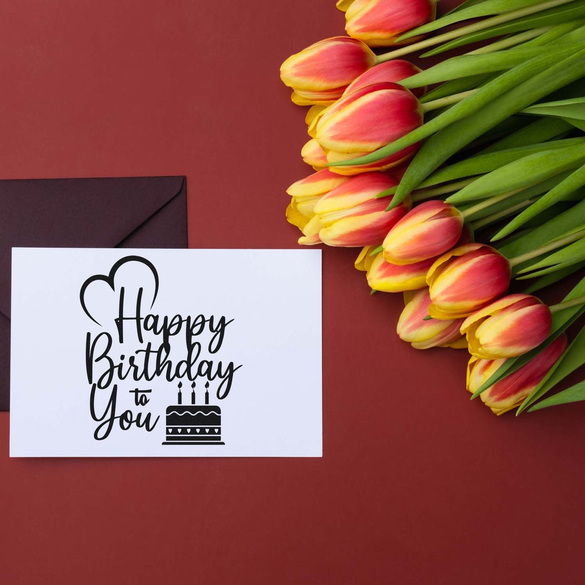 Happy Birthday to You rubber stamp on a greeting card with tulips and envelope, ideal for floral birthday messages.