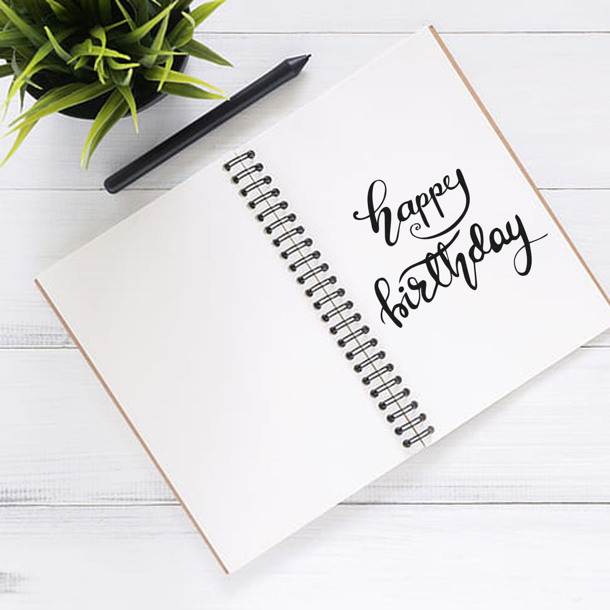 Happy Birthday rubber stamp on spiral notebook for handmade cards, scrapbook pages, and birthday crafting.