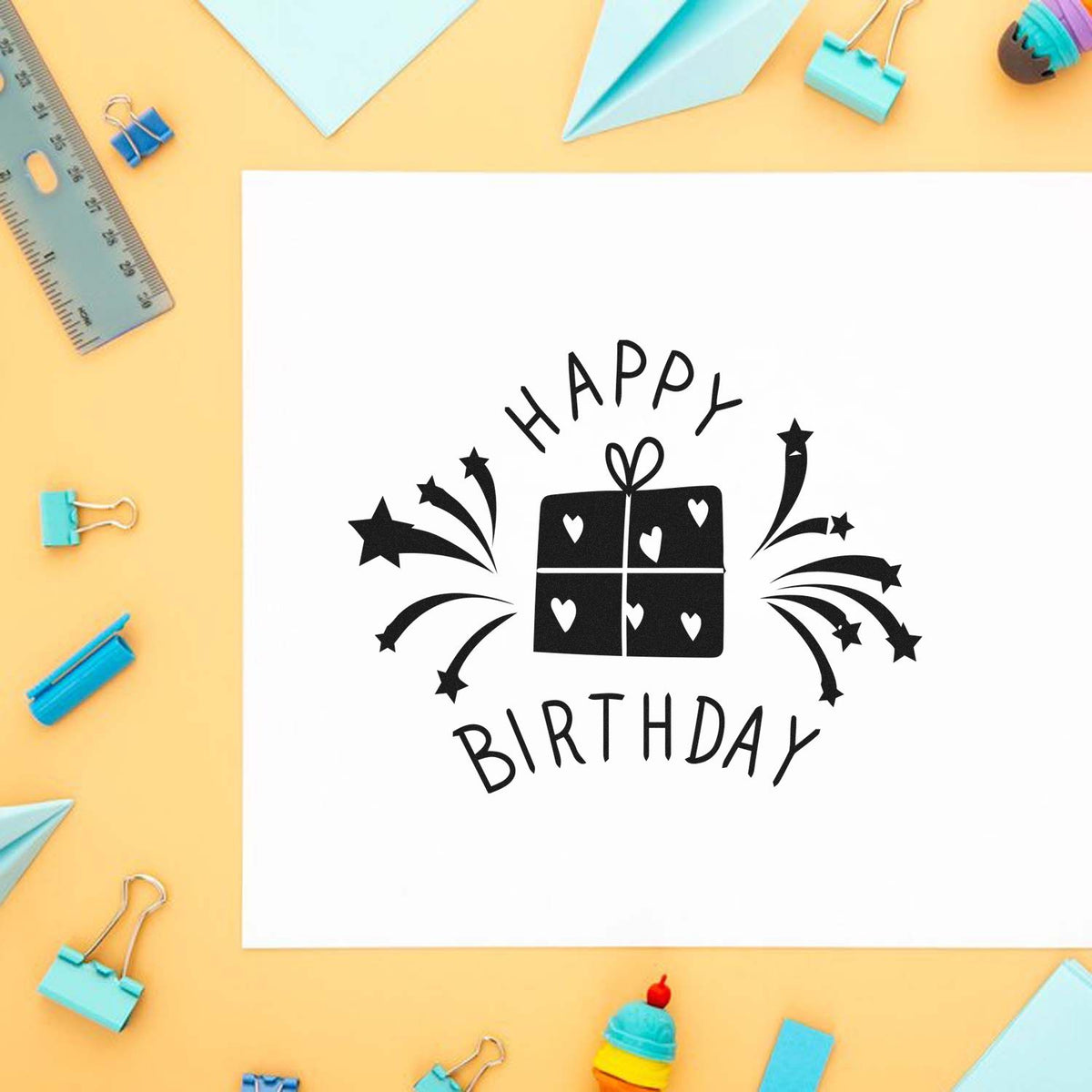 Happy Birthday rubber stamp design with gift and fireworks, perfect for handmade birthday cards and paper crafts.