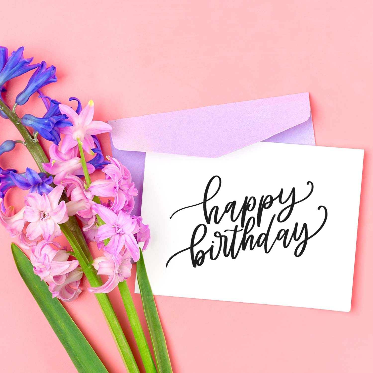 Happy Birthday rubber stamp design for greeting cards, shown on a floral card with pastel envelope.