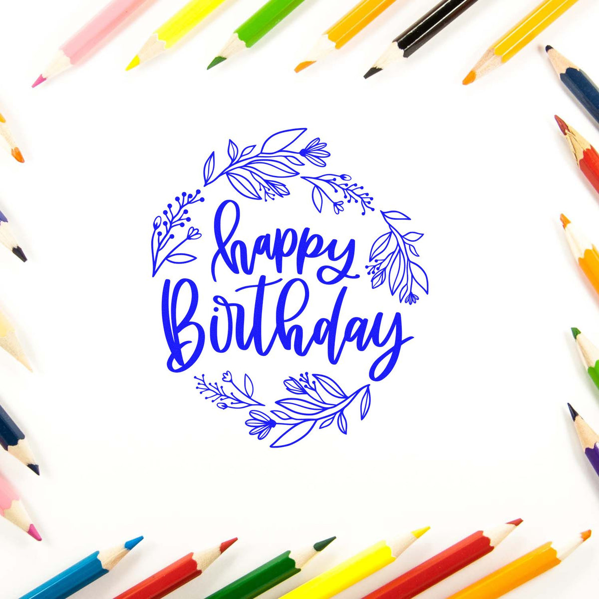 Happy Birthday floral rubber stamp design for greeting cards and crafts, surrounded by colored pencils.