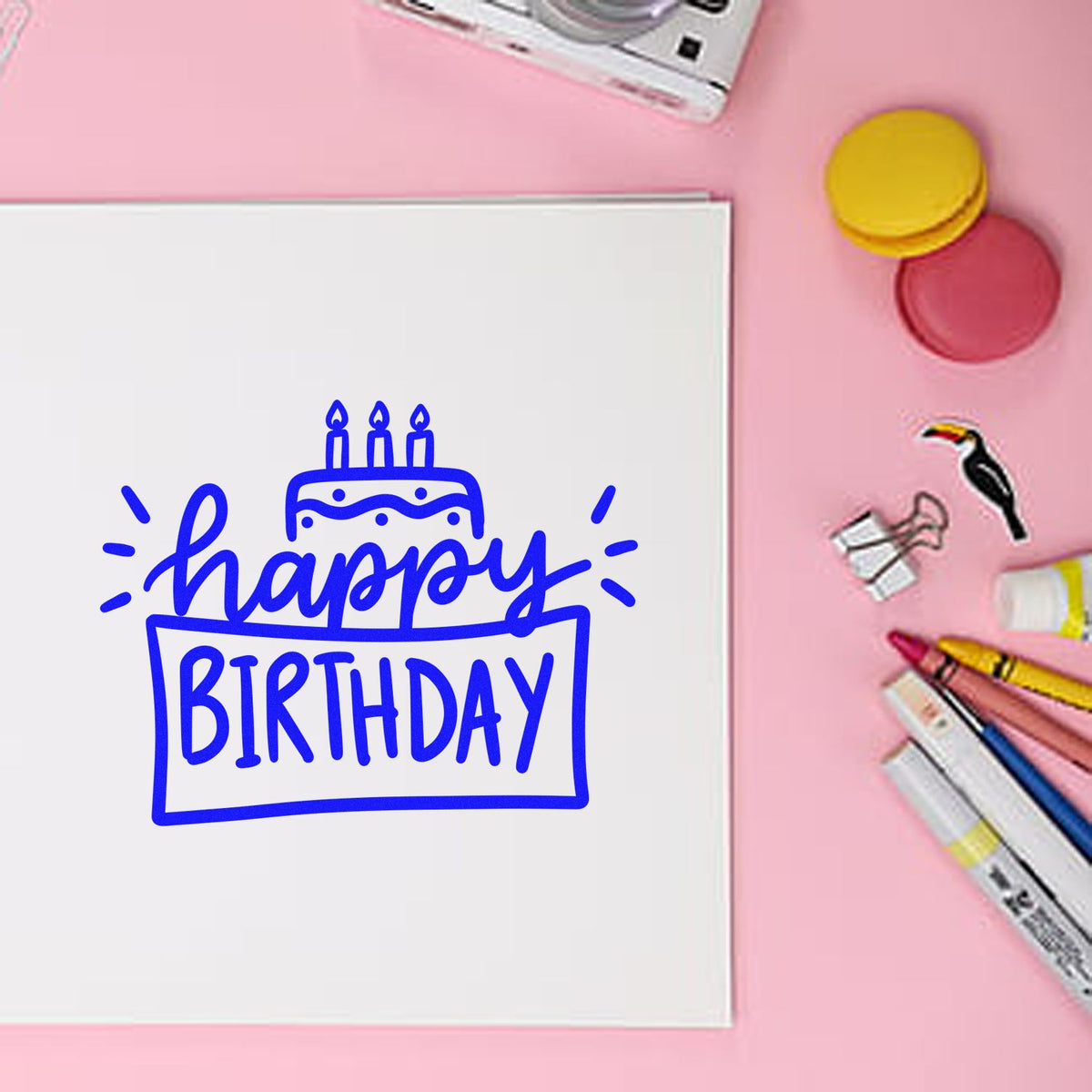 Happy birthday rubber stamp design on white card with markers and ink pads, ideal for custom birthday card crafting.