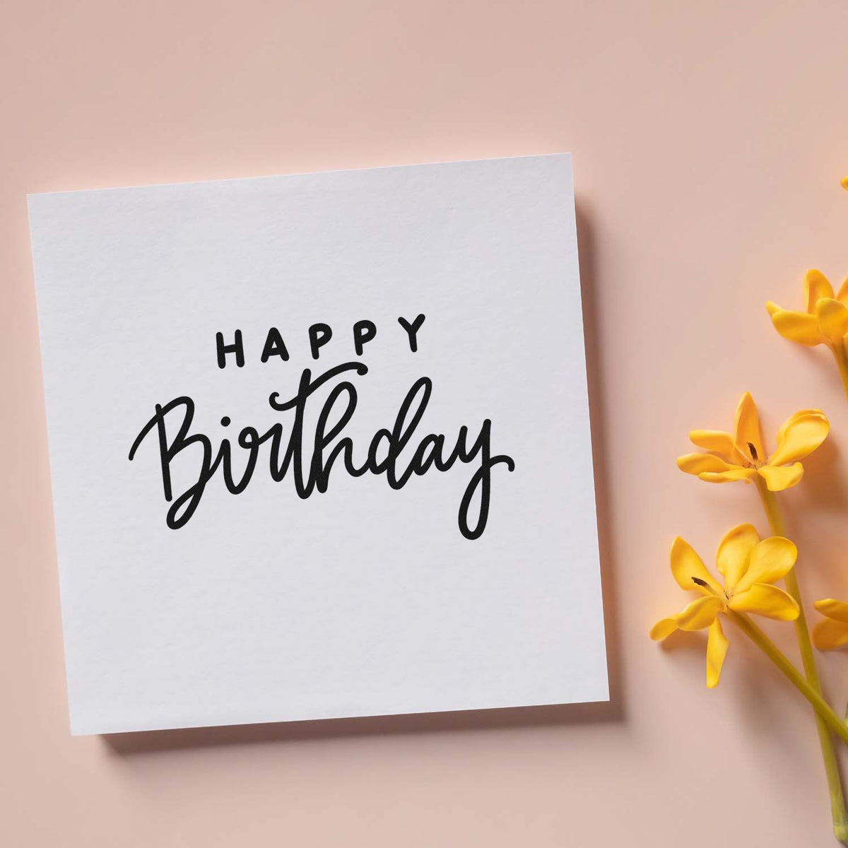 Happy Birthday rubber stamp impression on white card, ideal for handmade birthday cards and craft projects.