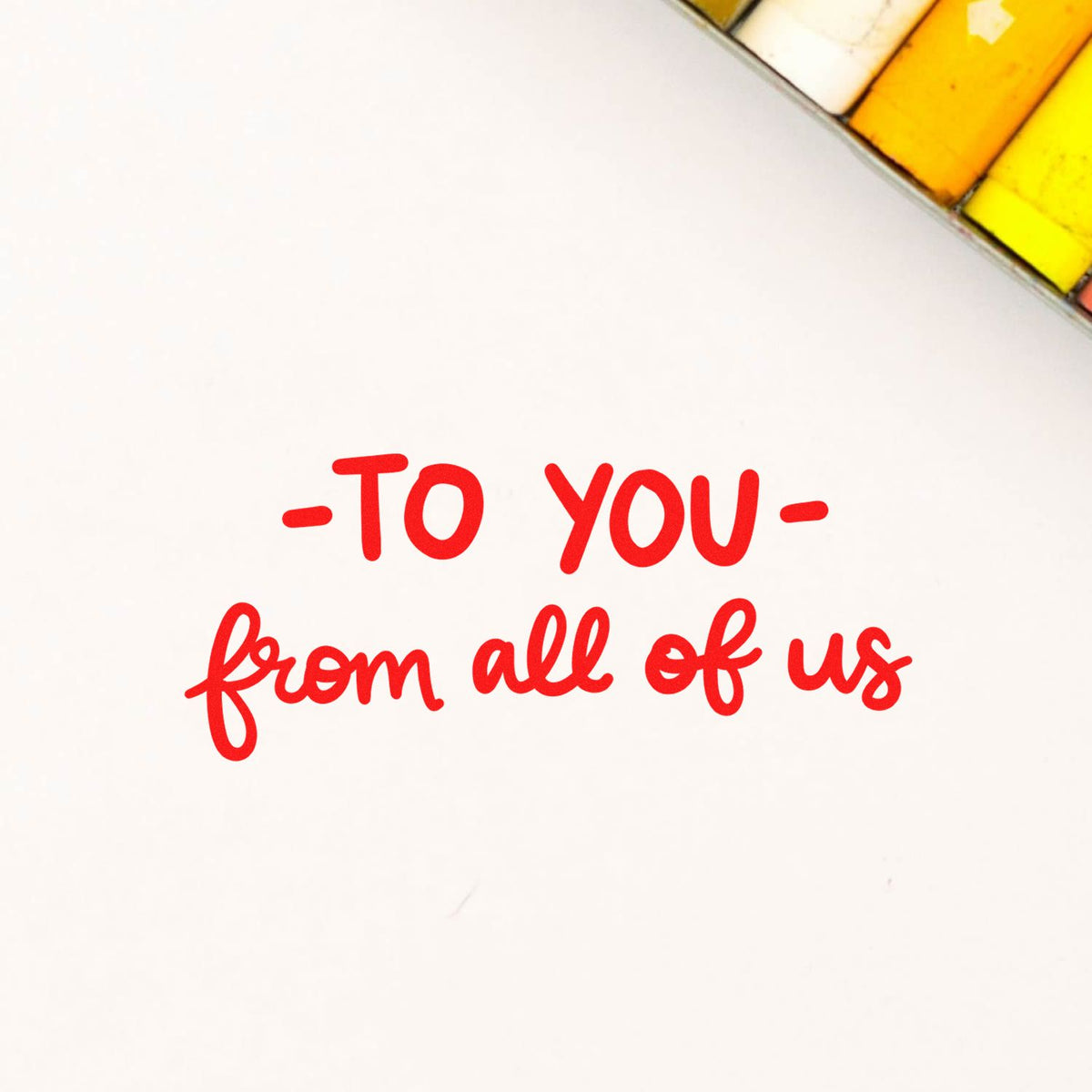 Custom rubber stamp reading To you from all of us for group gifts, thank-you cards, and packaging.