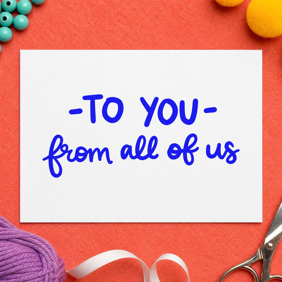 To You From All of Us craft stamp imprinted in blue ink on paper, a design suited to framed community board.