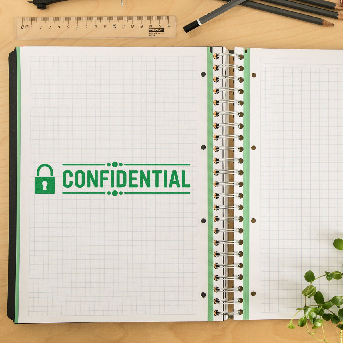 Confidential rubber stamp impression on open notebook for marking sensitive documents and office files.
