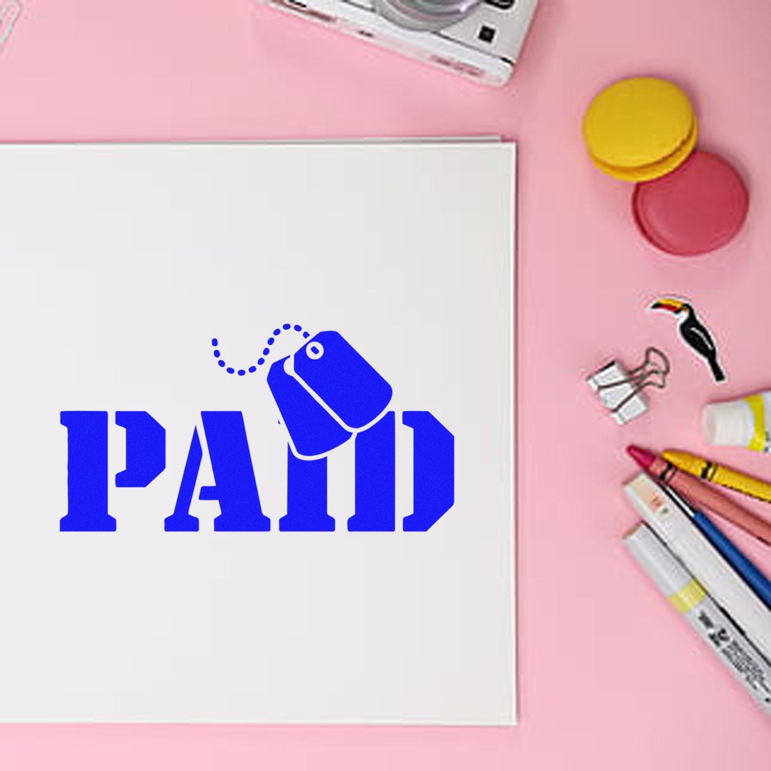 Blue PAID rubber stamp on paper with office supplies, ideal for invoice processing and accounting records.
