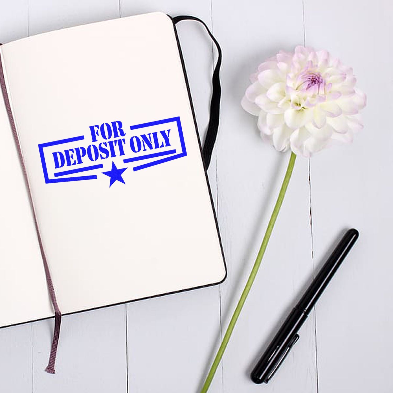 Blue For Deposit Only rubber stamp impression on notebook, ideal for banking and check processing.