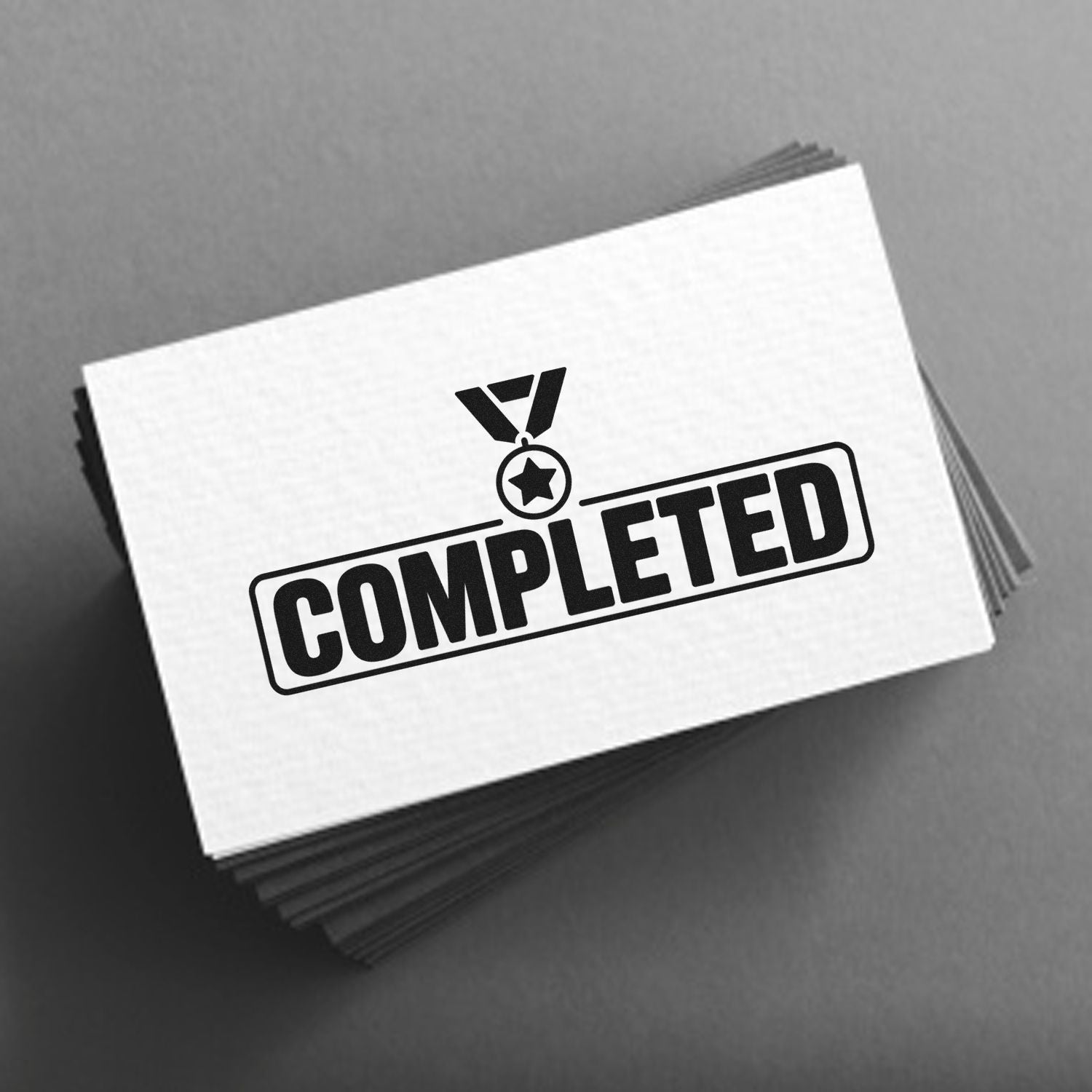 Completed rubber stamp on stacked cards for marking approved, finished documents and office paperwork.