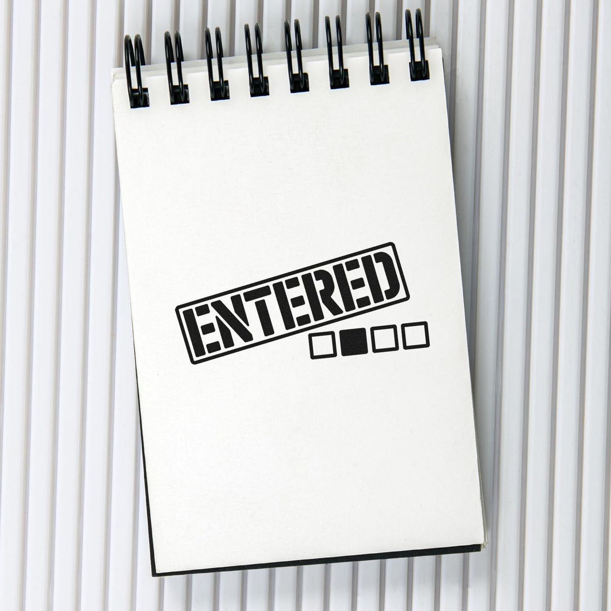 Entered rubber stamp imprint on notepad for office document processing and record tracking