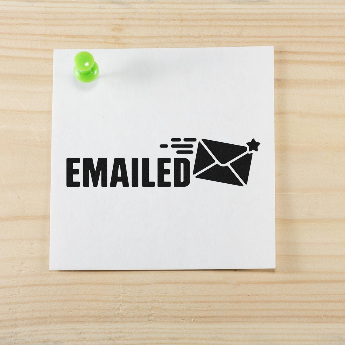 Emailed rubber stamp impression with envelope icon on paper, used to mark completed email correspondence.