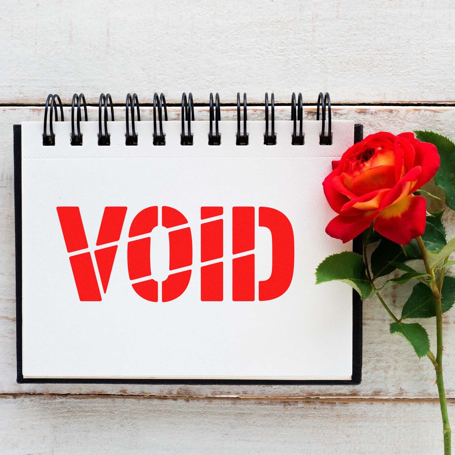 VOID rubber stamp design in bold red stencil style on a notebook page, ideal for office, craft, and labeling use.