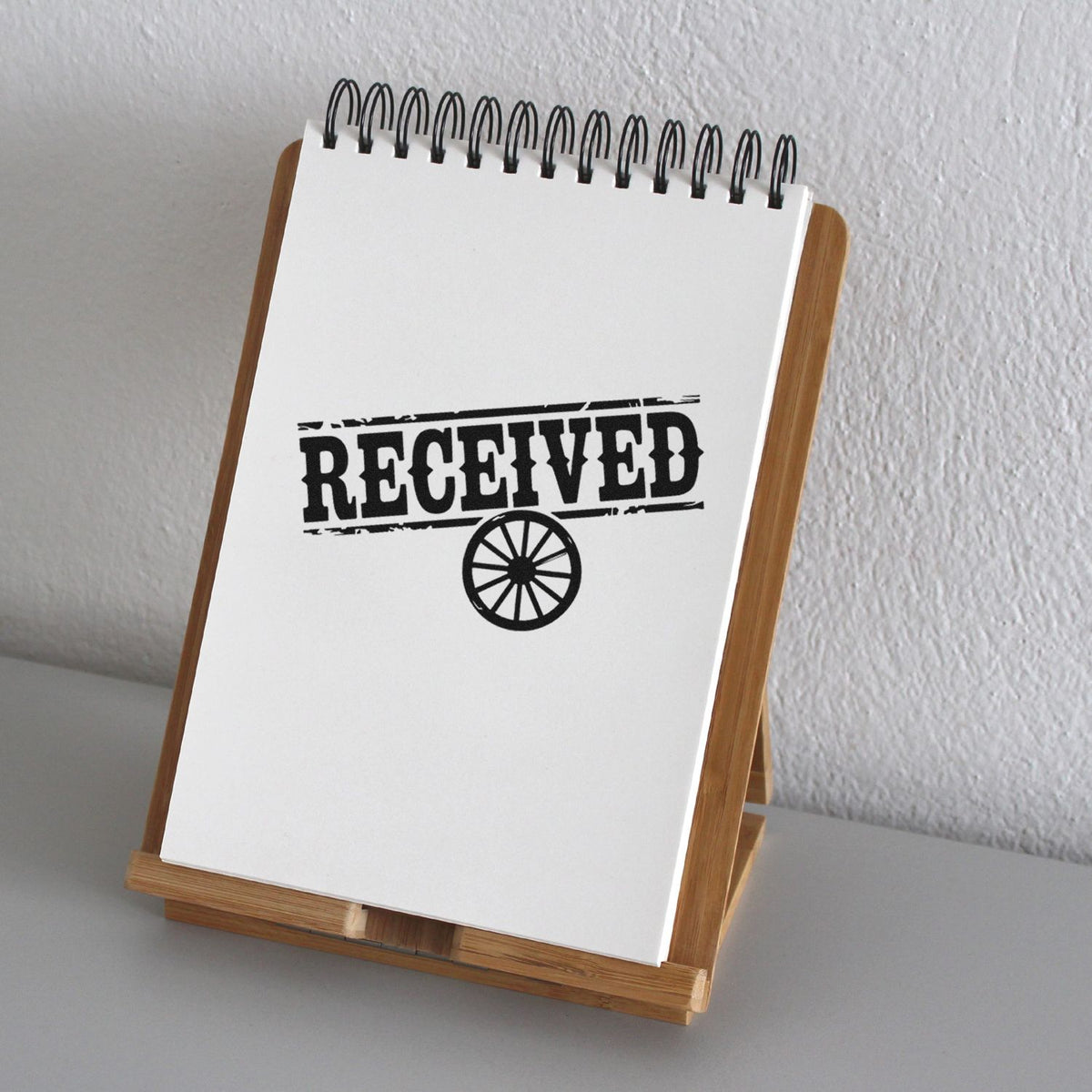 Received rubber stamp impression on notebook page, ideal for office mailroom document tracking and approval marking.