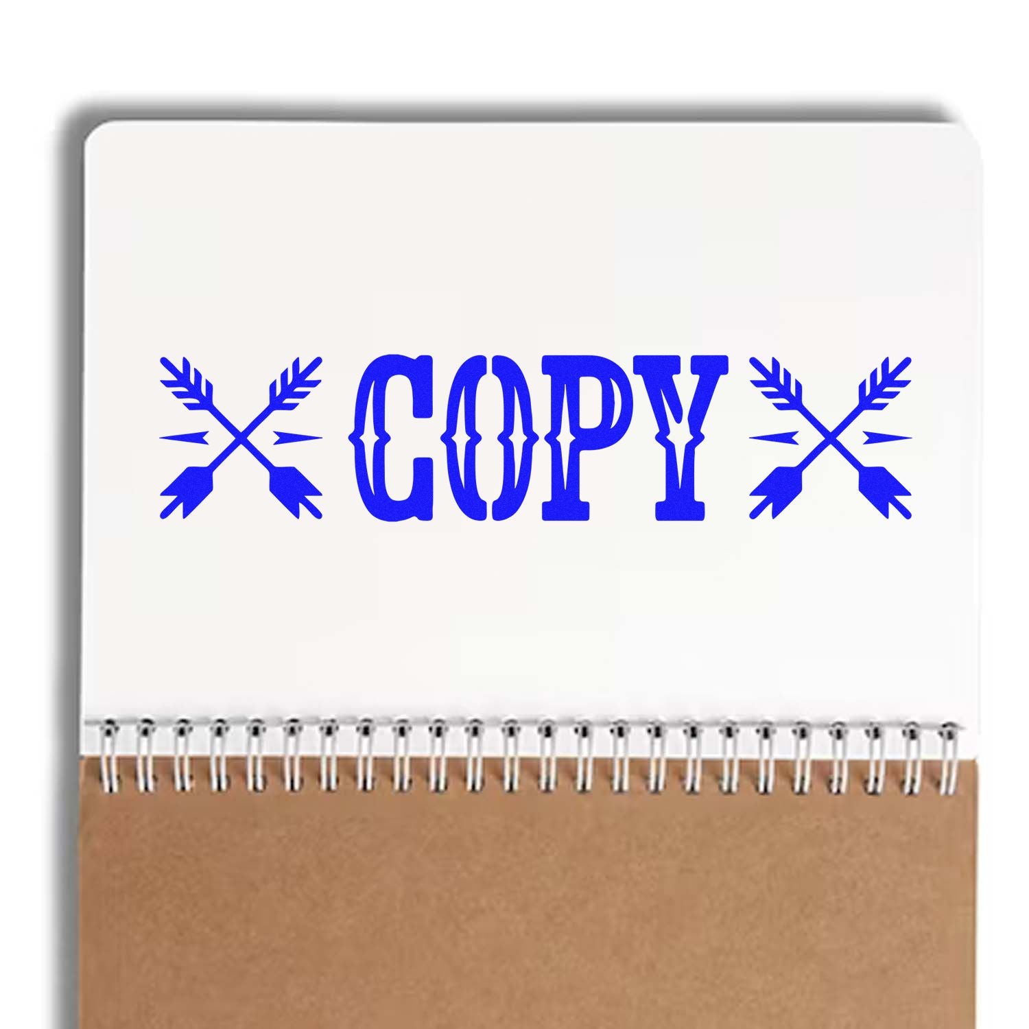 Blue Copy rubber stamp design with crossed arrows on notebook mockup for office document marking.