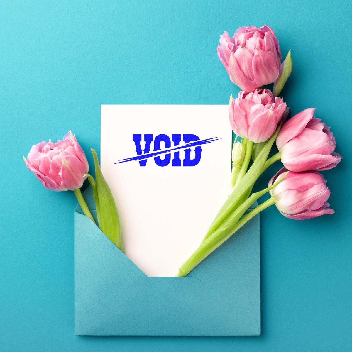 VOID rubber stamp on a card in an envelope with pink tulips, for document cancellation and office use.