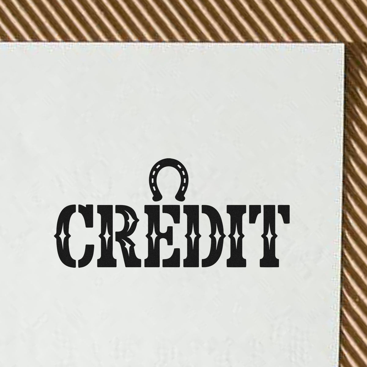 Western-style CREDIT rubber stamp design with horseshoe icon for rustic business branding and craft projects.