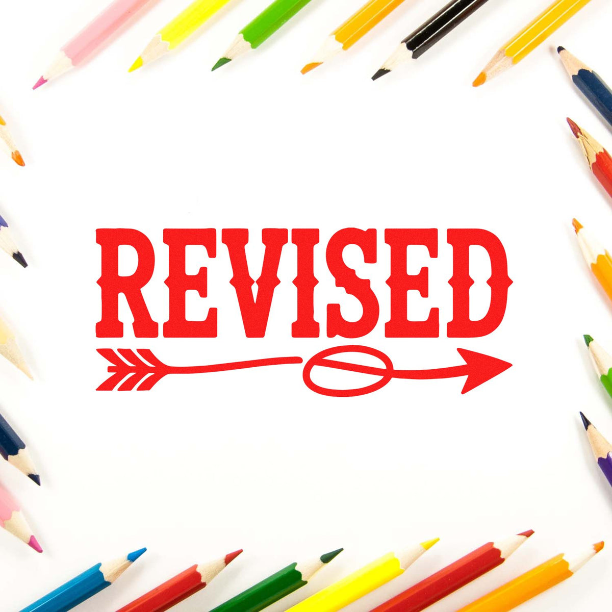 Red REVISED rubber stamp with arrow, framed by colored pencils for document review or approval marking.
