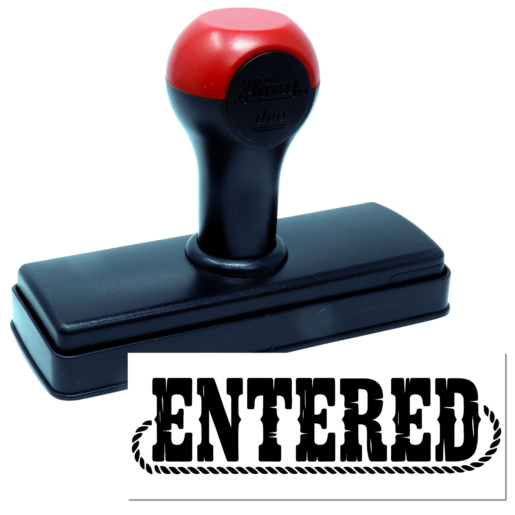 Self-inking rubber stamp with ENTERED imprint for office document processing and file marking.