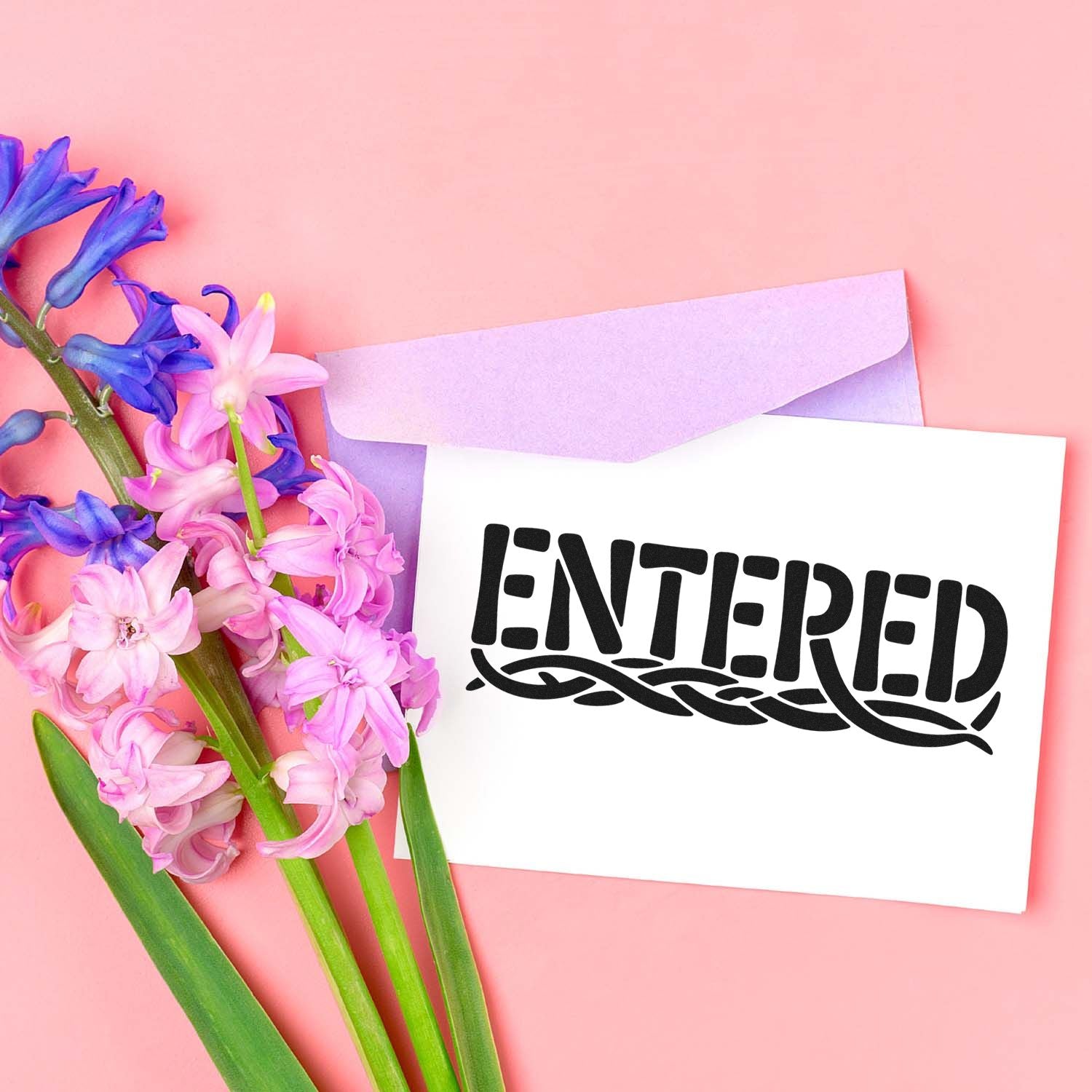 ENTERED rubber stamp design on floral stationery with envelope and pink flowers on a pastel pink background.