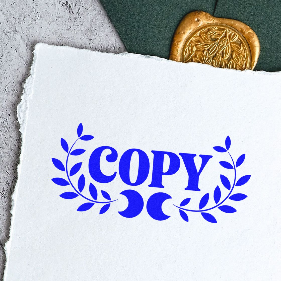 Blue COPY rubber stamp impression with laurel wreath on textured paper for office document marking.