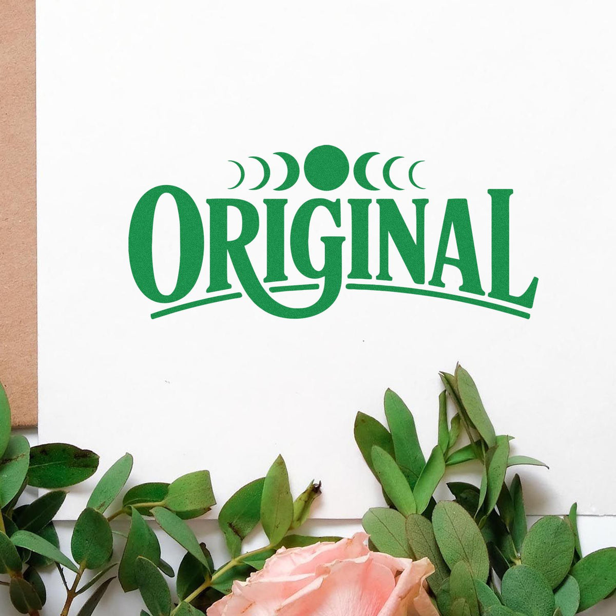 Original moon phase rubber stamp design stamped in green on stationery, ideal for custom branding and packaging.