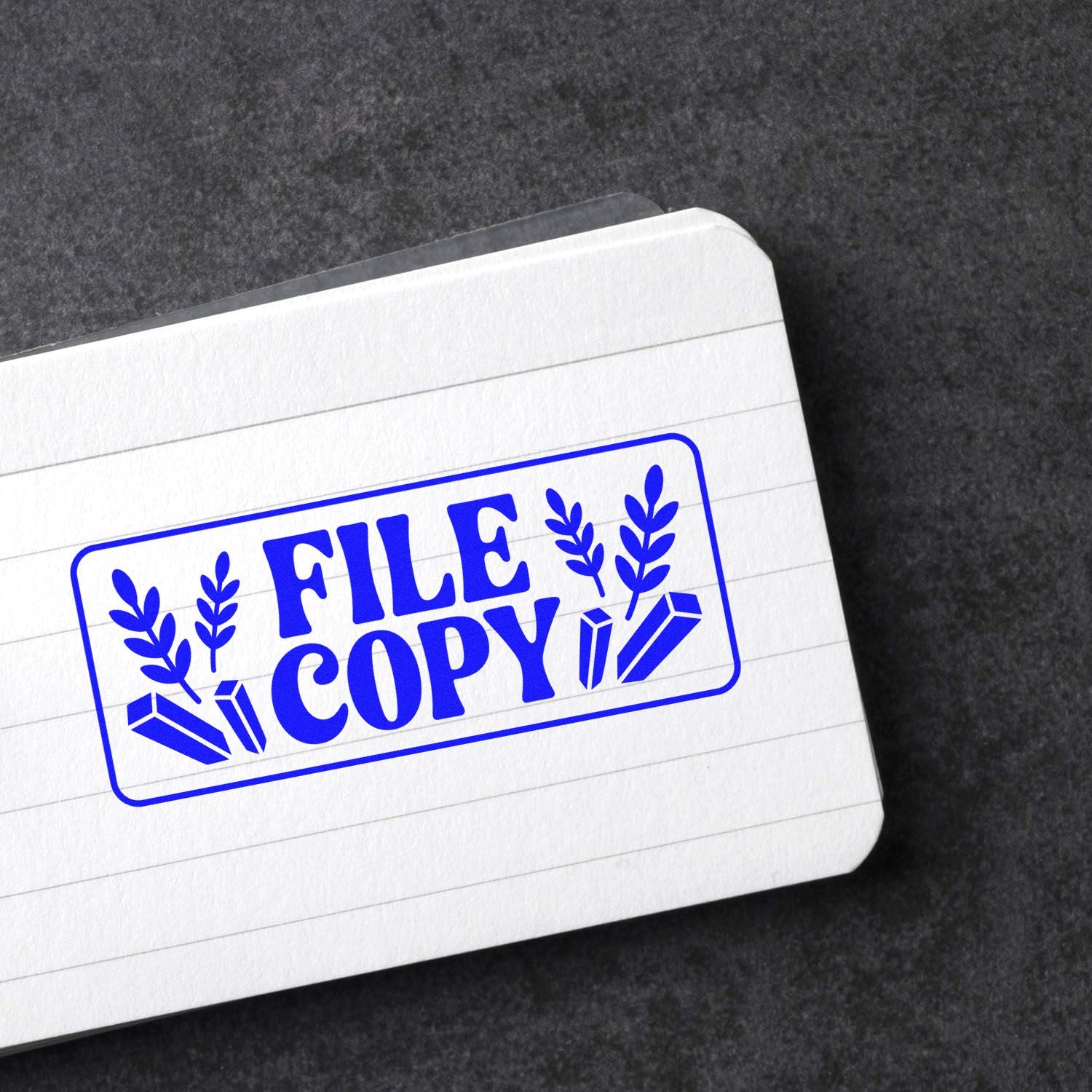 Blue FILE COPY rubber stamp impression on lined notebook paper, ideal for office document marking.