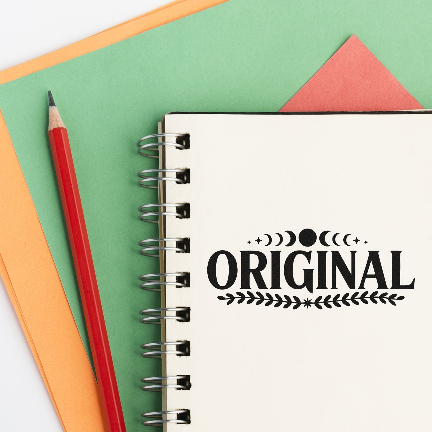 Original rubber stamp design on spiral notebook, ideal for stationery branding, crafts, and handmade packaging.