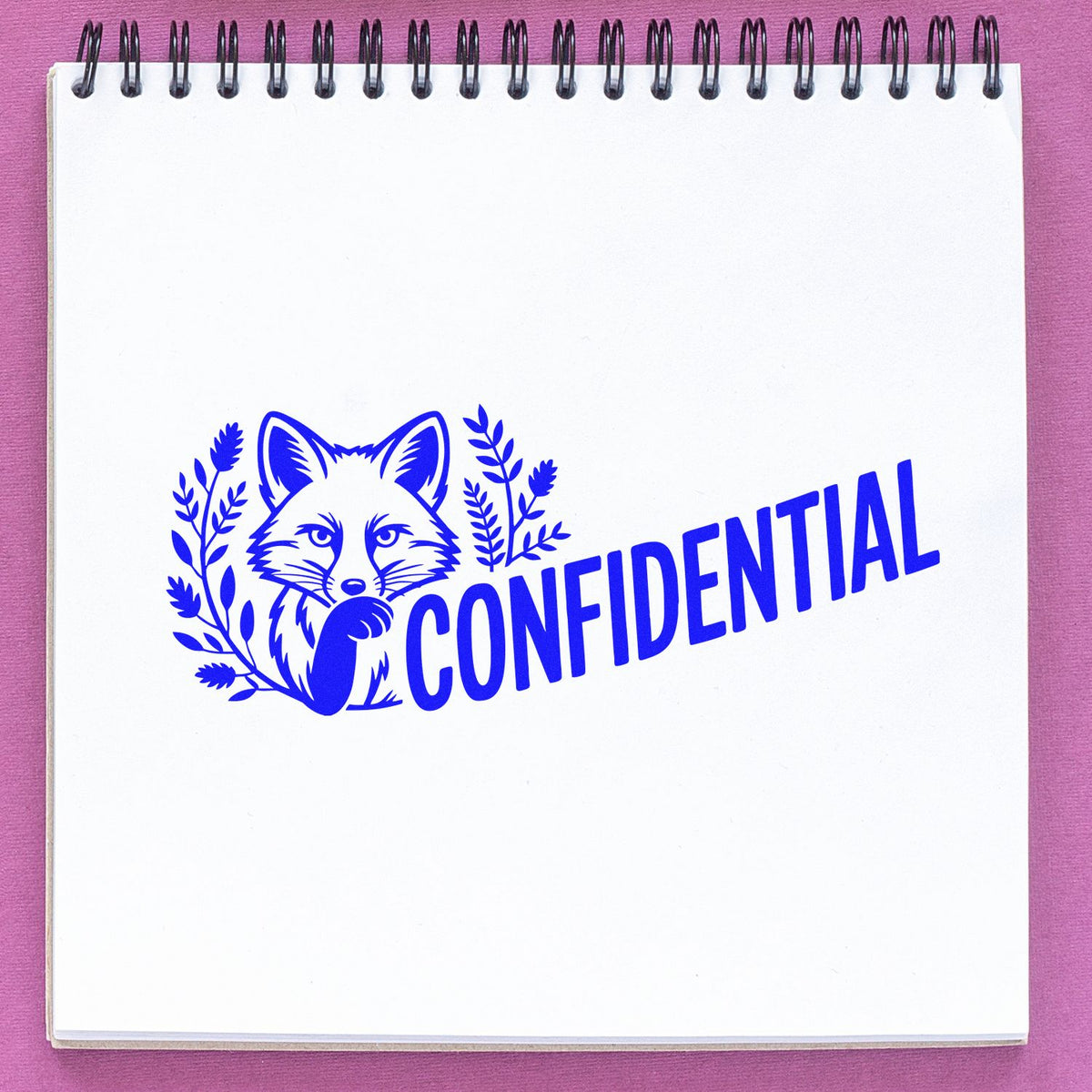 Confidential fox rubber stamp on notebook page with blue ink, ideal for office document marking and custom stamp branding.
