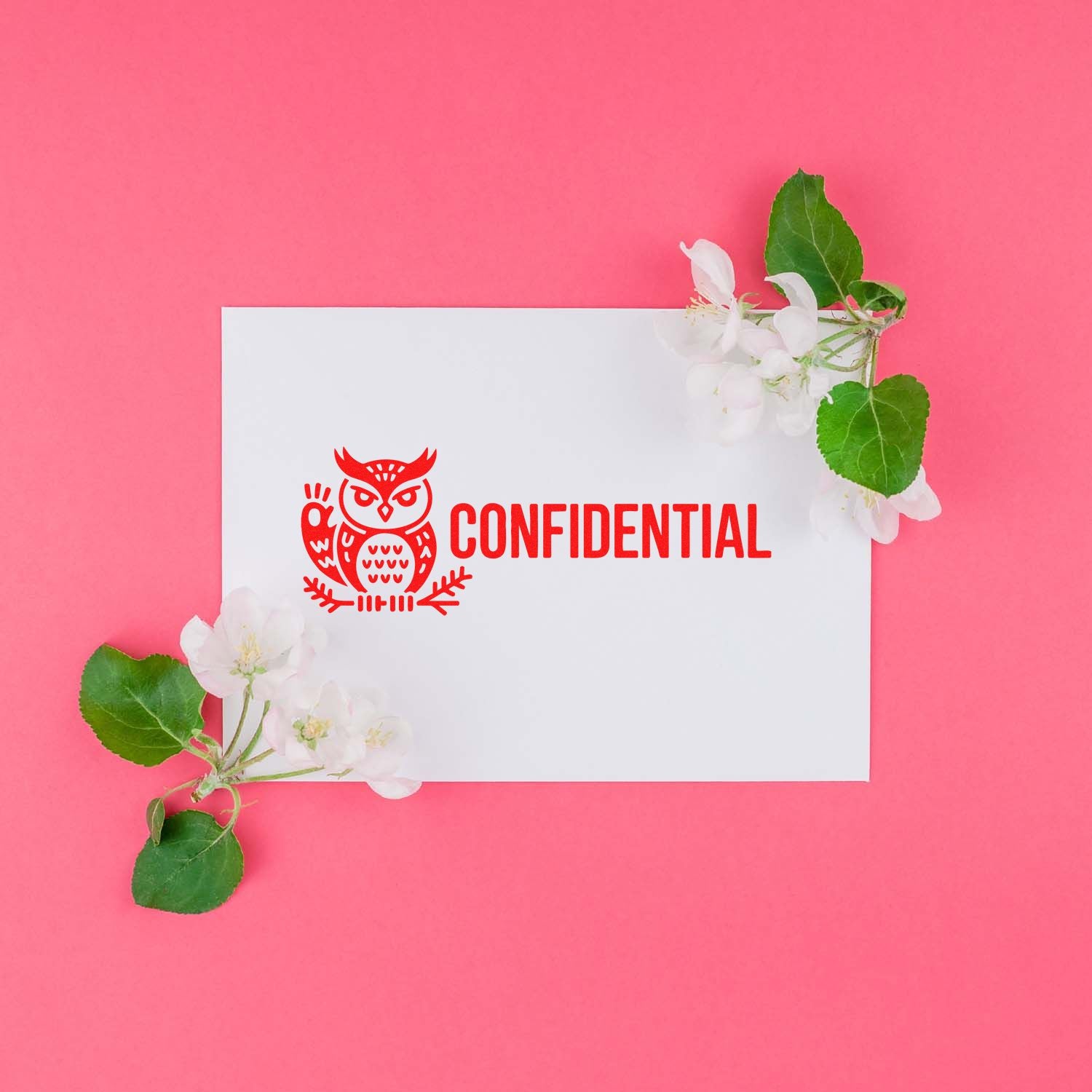 Confidential rubber stamp with owl icon on white card, styled with flowers on pink background.