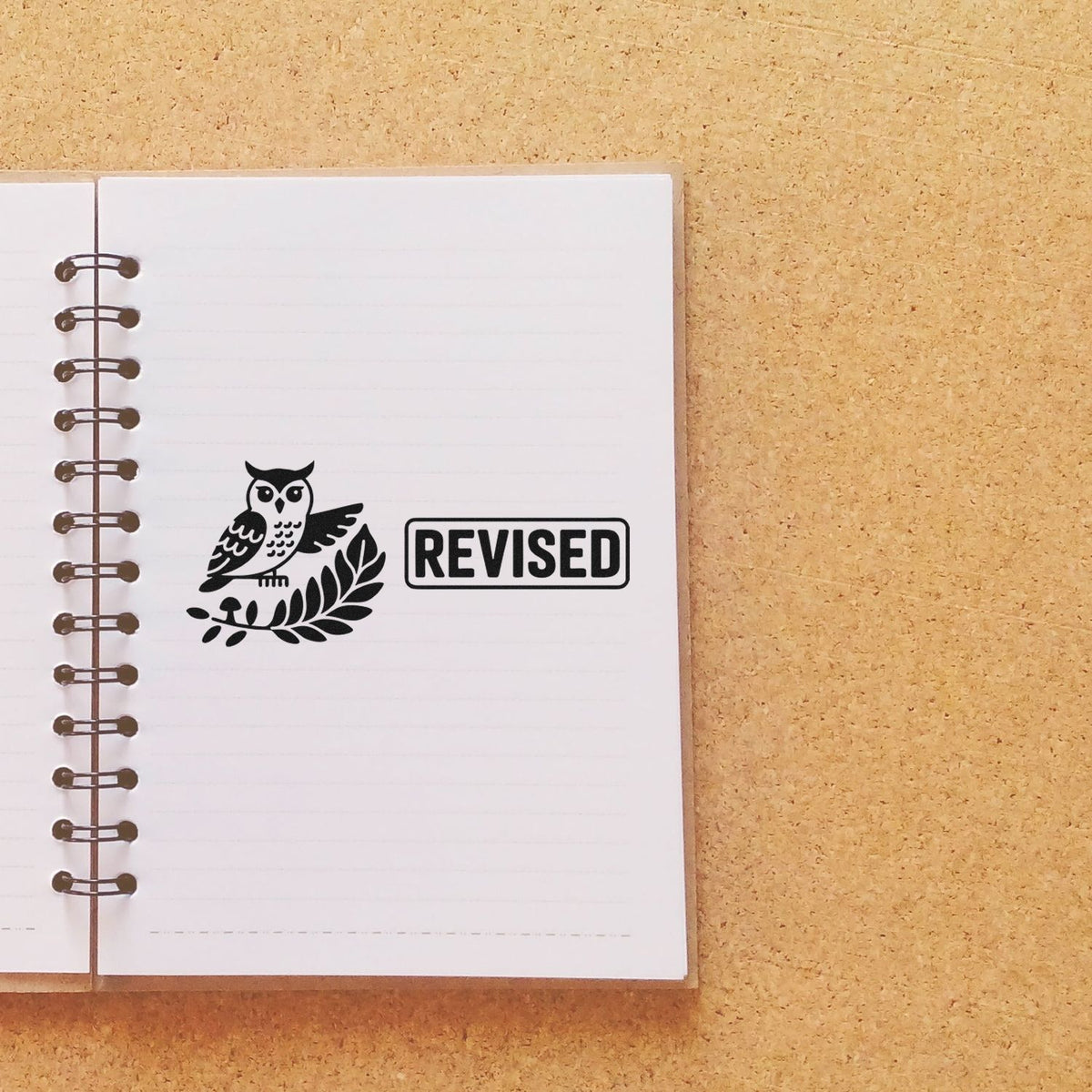 Owl revised rubber stamp on notebook page for marking edited documents, notes, and schoolwork.