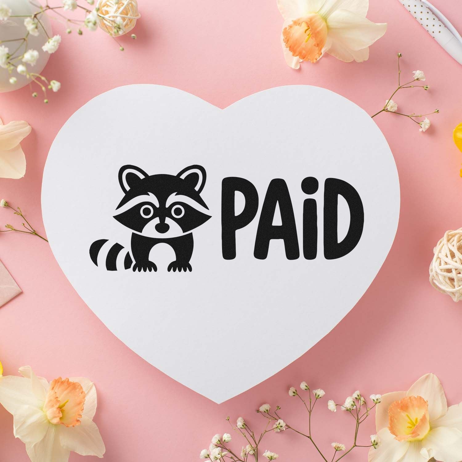 Raccoon PAID rubber stamp design on heart-shaped card, ideal for craft business, planner, and invoice marking.