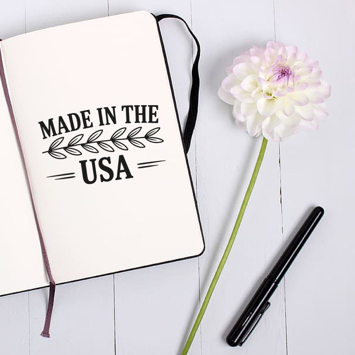 Made in the USA rubber stamp design on notebook, perfect for handmade product packaging and branding.
