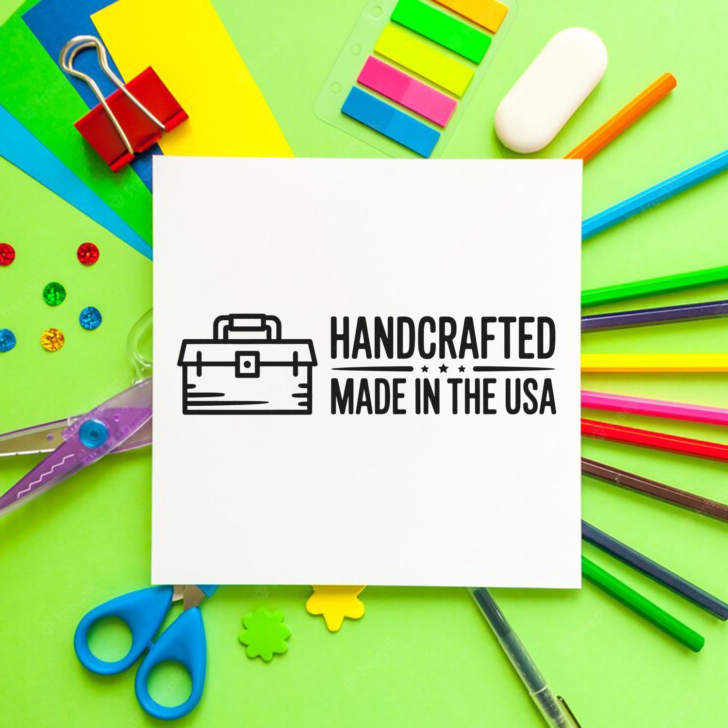 Handcrafted made in the USA rubber stamp design on paper with colorful craft supplies, ideal for custom branding.