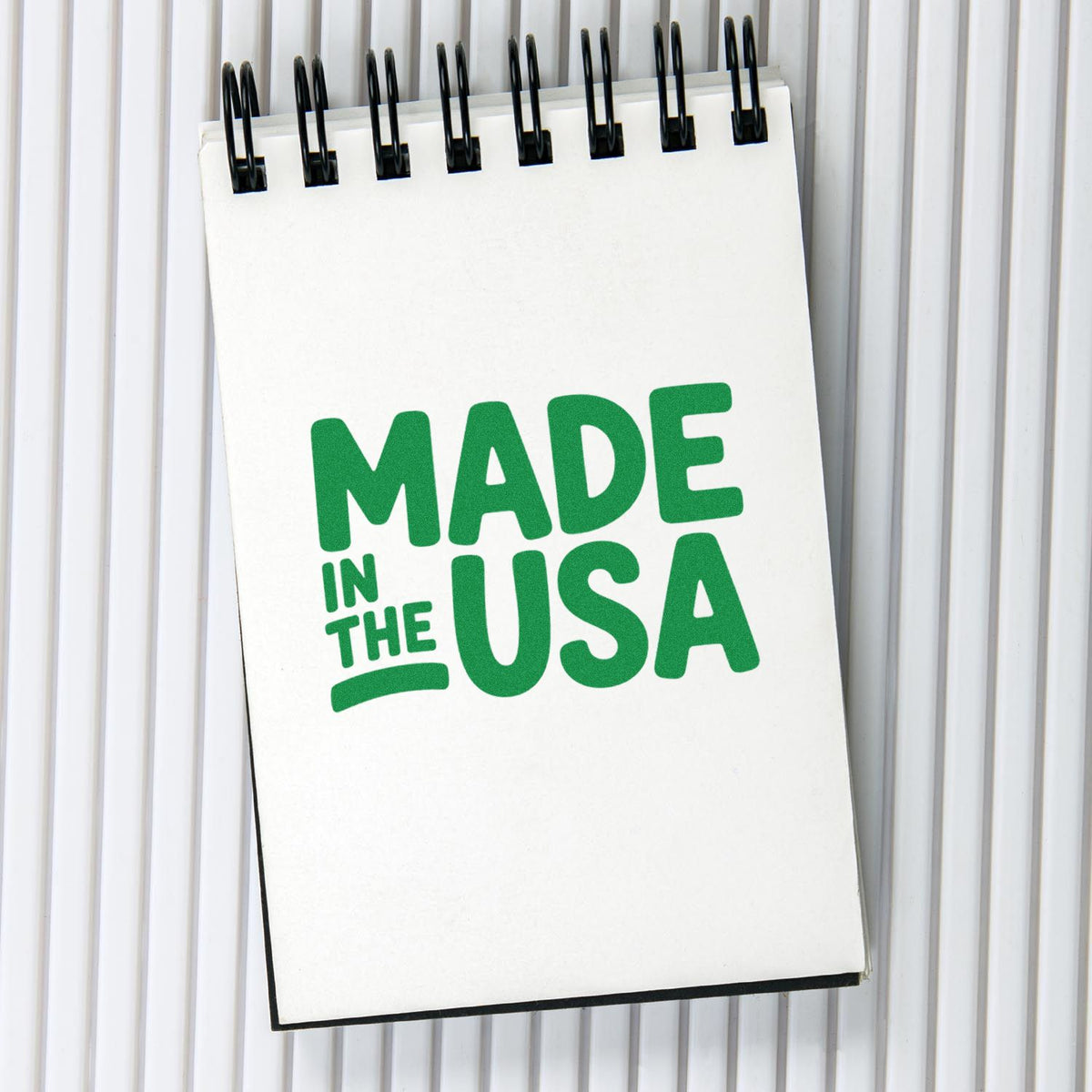 Made in USA custom rubber stamp design on a spiral notebook, ideal for patriotic packaging and branding.