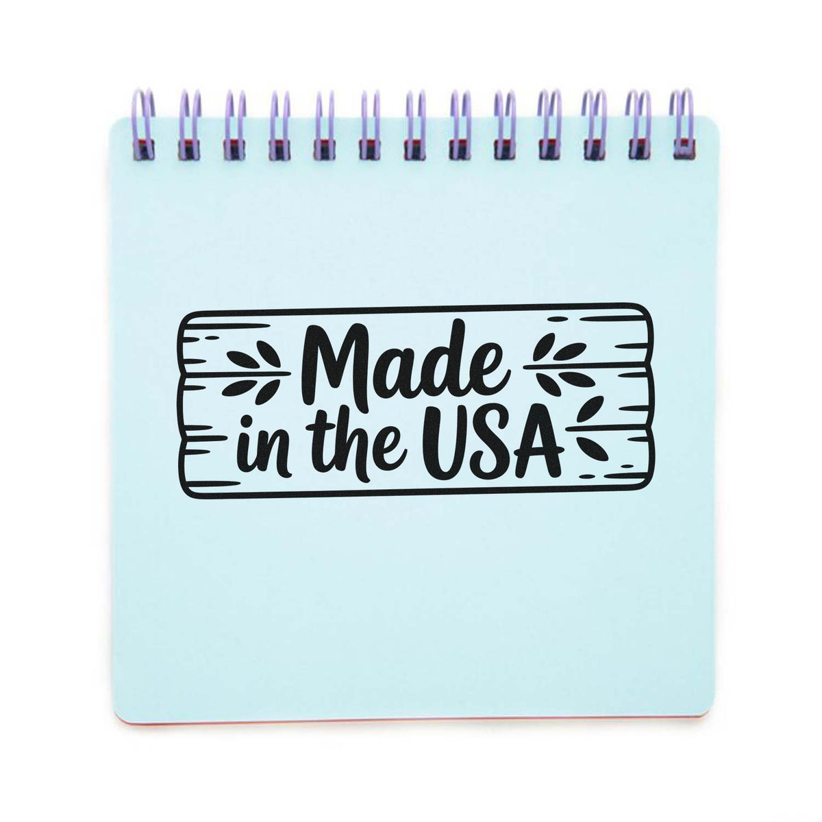 Made in the USA rubber stamp design on a notepad, ideal for handmade product packaging and patriotic branding.