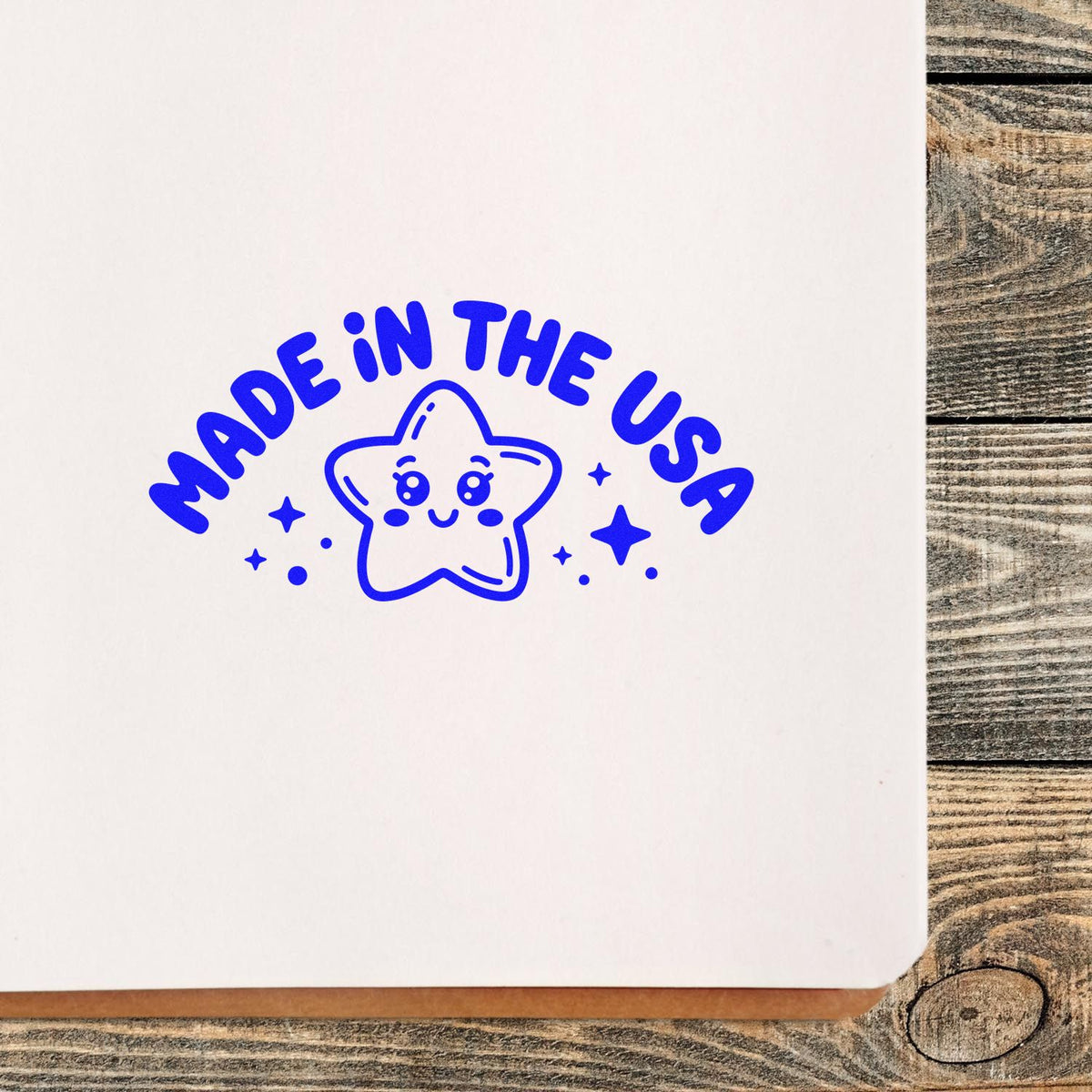 Blue Made in the USA rubber stamp impression with smiling star, ideal for custom packaging and small business branding.