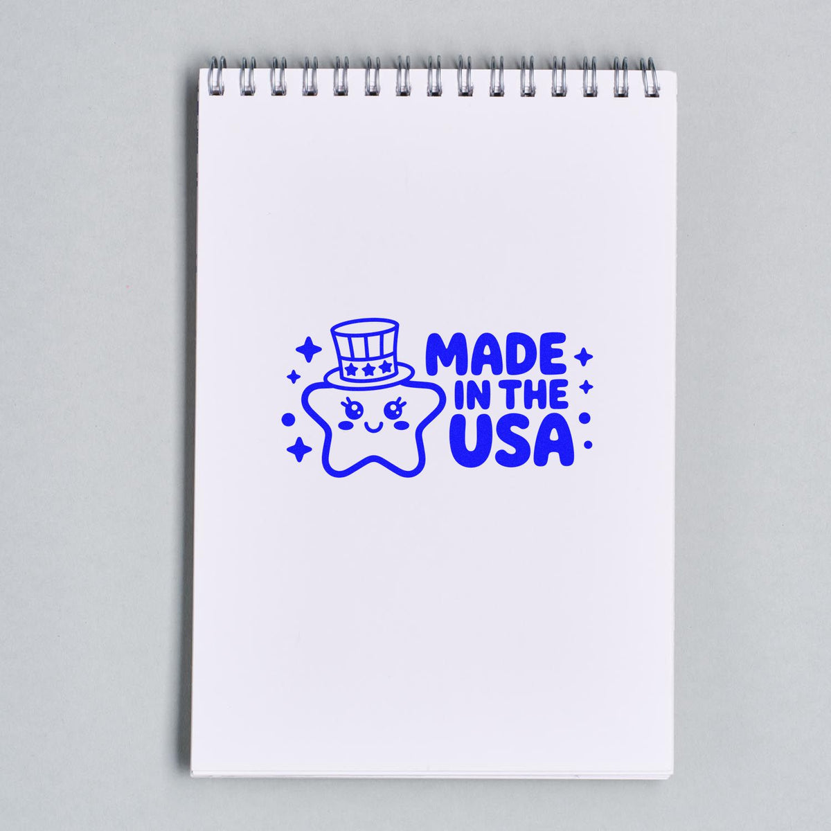Made in the USA rubber stamp design with cute star mascot on notebook mockup for patriotic branding